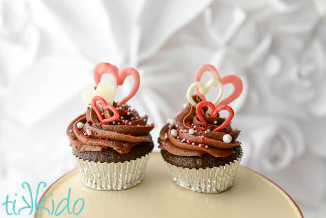 Two Valentine's day cupcakes decorated with chocolate heart Valentine's day cupcake toppers