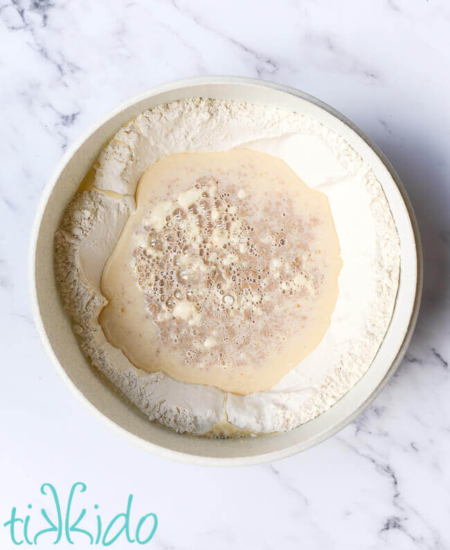 Ingredients for cinnamon roll dough in a large bowl.