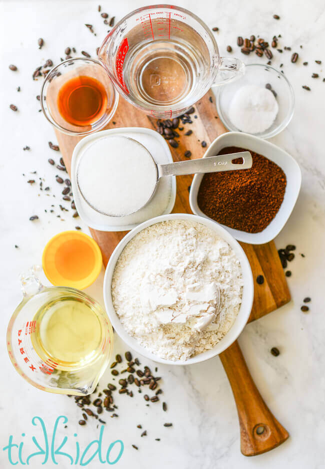 Coffee cupcakes ingredients on a wooden cutting board, surrounded by coffee beans.