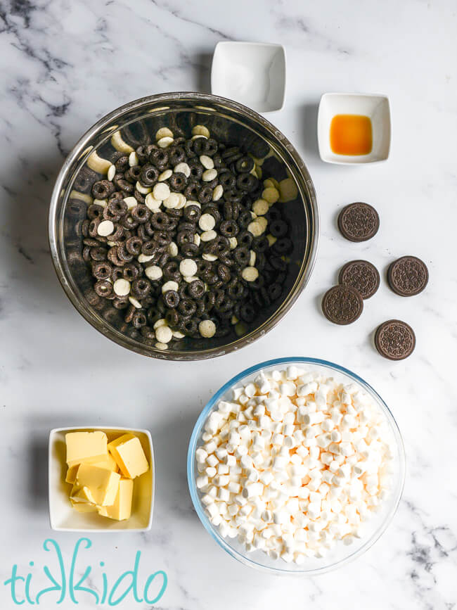 Ingredients for Cookies and Cream Cereal Treats on a white marble surface.