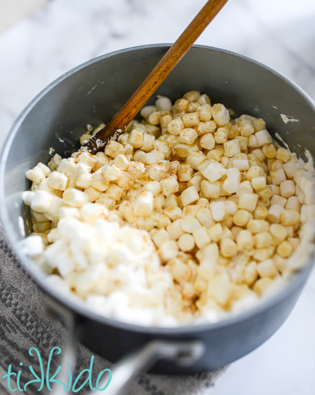 Browned butter and marshmallows melting in a saucepan to make Cookies and Cream Cereal Treats.