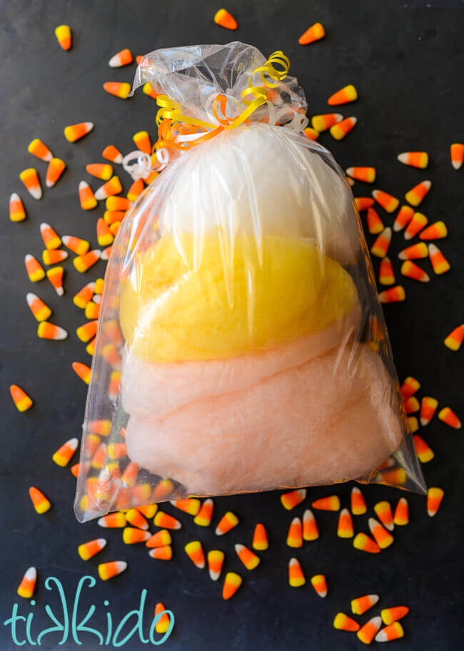 Candy Corn Cotton Candy on a black chalkboard background surrounded by candy corn candies.