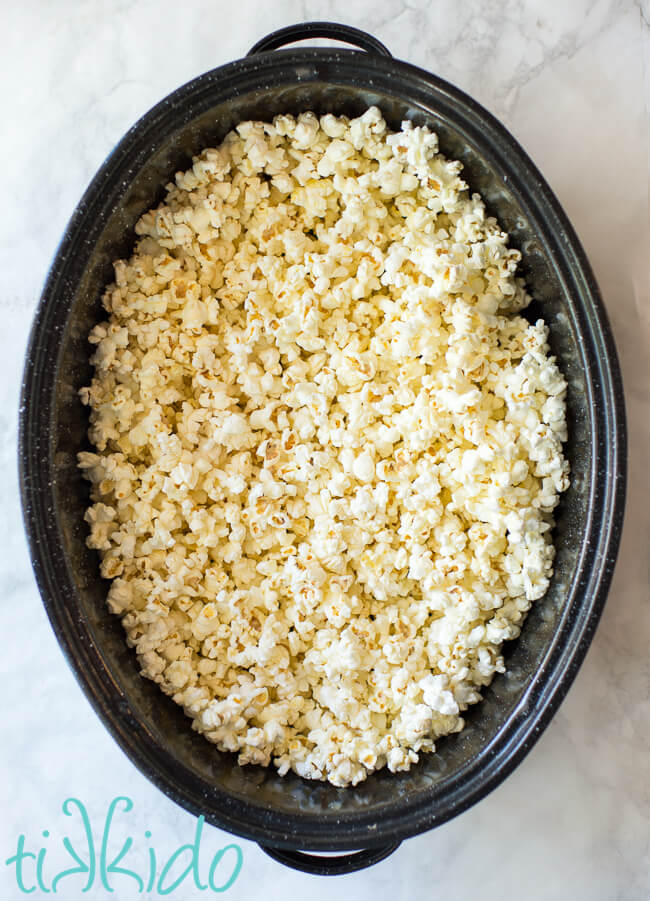 Popcorn in a roasting pan for making cotton candy popcorn recipe.