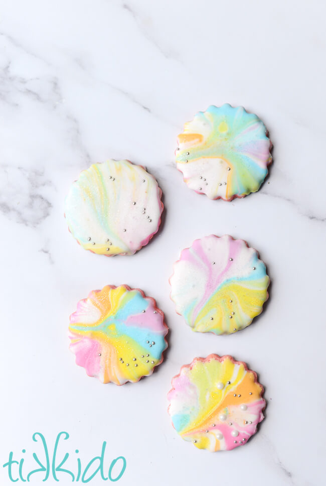 Cotton candy sugar cookies decorated with a pastel rainbow of marbleized royal icing.