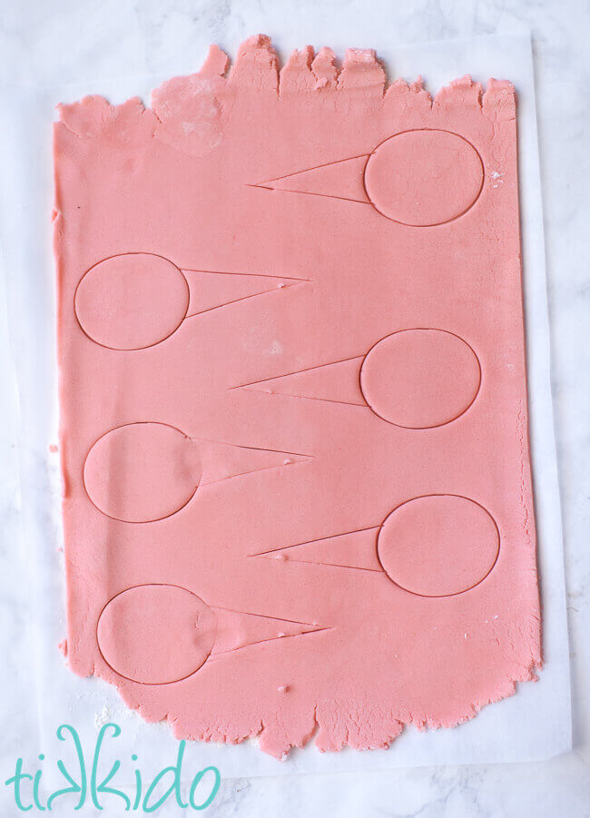 Cotton candy sugar cookie dough rolled out and cut into cotton candy shapes.