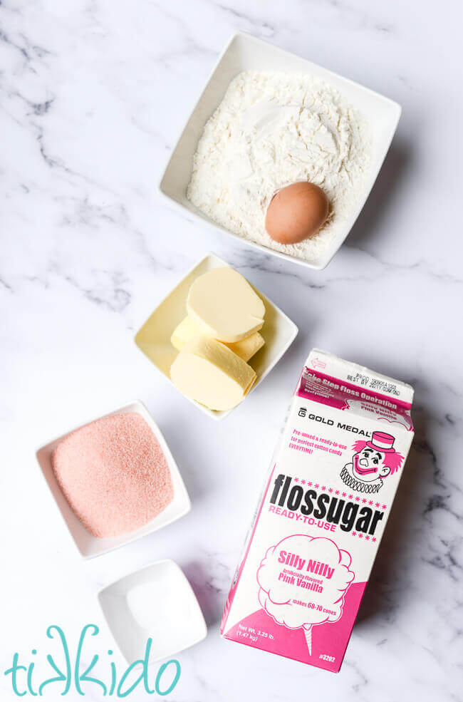 Ingredients for cotton candy sugar cookies on a white marble surface.