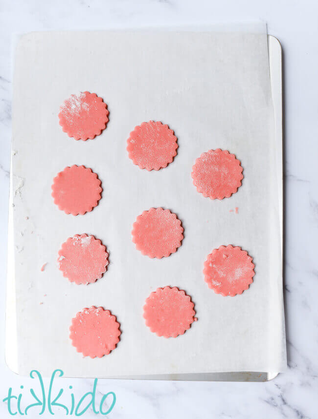 Unbaked cotton candy cookies on a parchment lined cookie sheet.