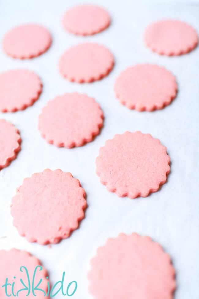 Cotton candy cookies baked on a parchment lined cookie sheet.