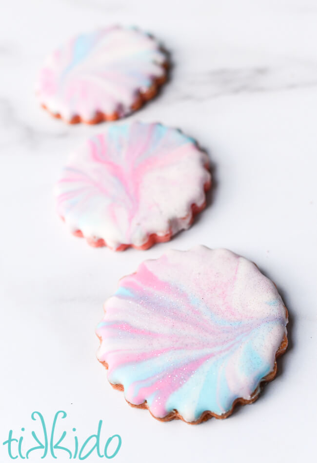 Cotton candy cookies decorated with marbleized pink, blue, and lavender royal icing.