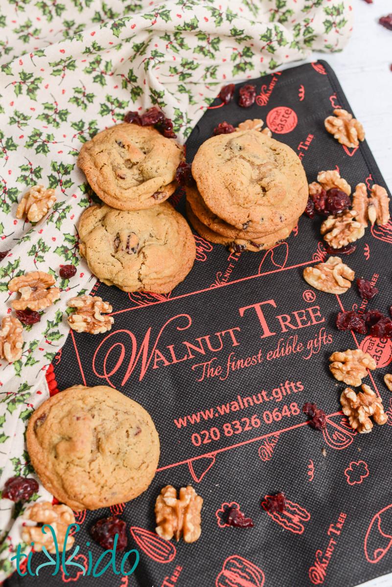 Cranberry Walnut Cookies, walnuts, and dried cranberries scattered on a bag from Walnut Tree Gifts.
