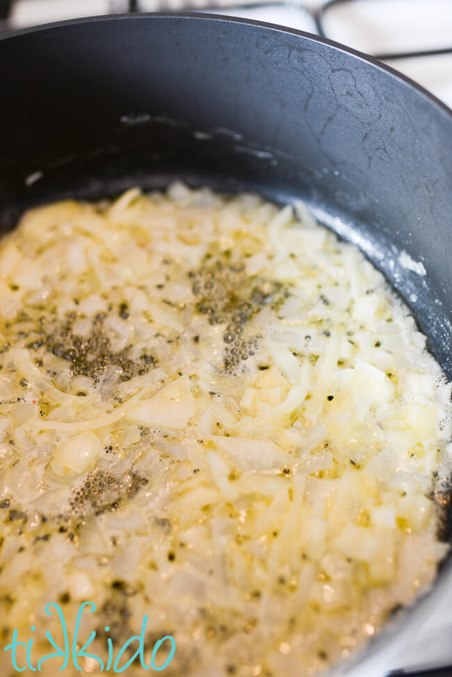 Onions and garlic being cooked in a pan for a Cream of Mushroom Soup Recipe.