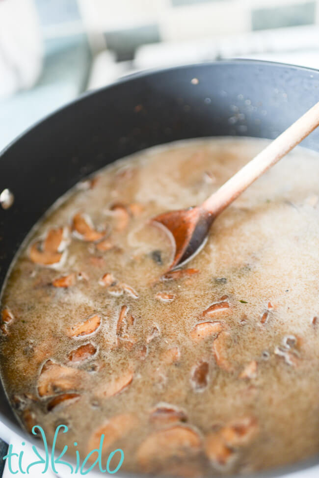 Chicken broth added to cooked mushrooms to make a Cream of Mushroom Soup Recipe.