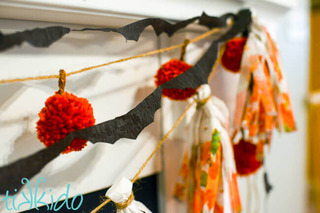 Tutorial for making a bat garland out of crepe paper for Halloween, including a free printable bat template.