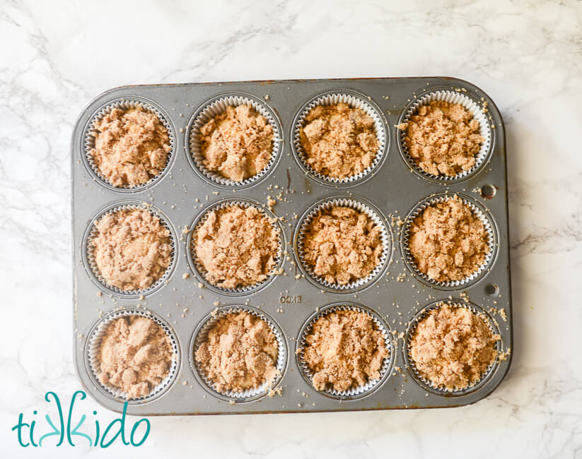 Streusel Topping for Muffins on batter in a muffin tin.