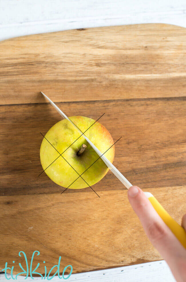 Apple being cut and cored using pastry chef techniques.