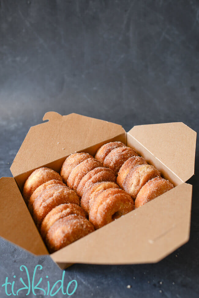 Box of homemade cinnamon sugar cake doughnuts.