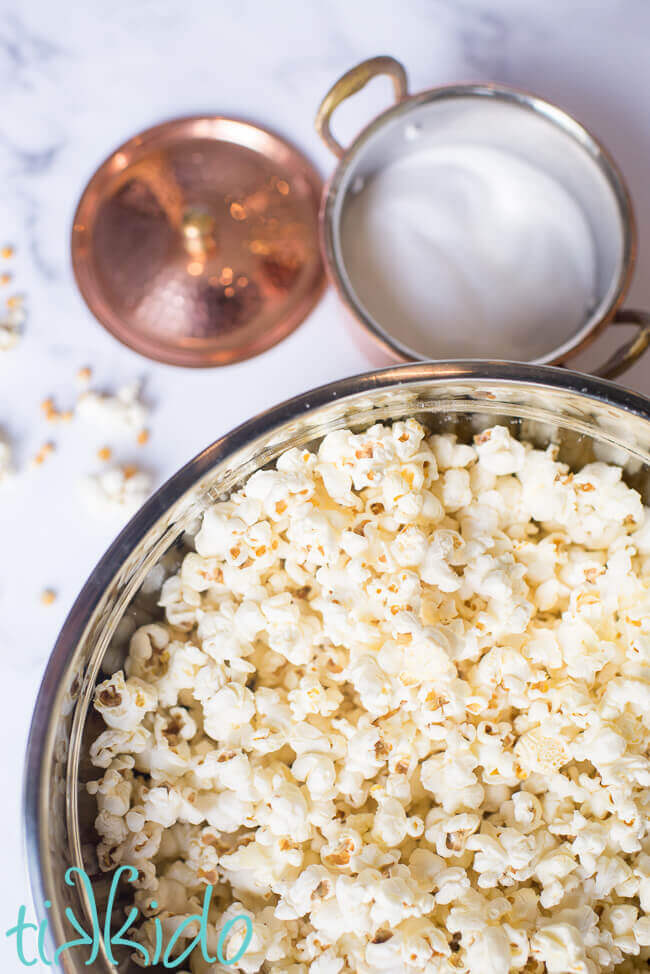 Duck fat popcorn in a large bowl, next to a copper salt cellar.