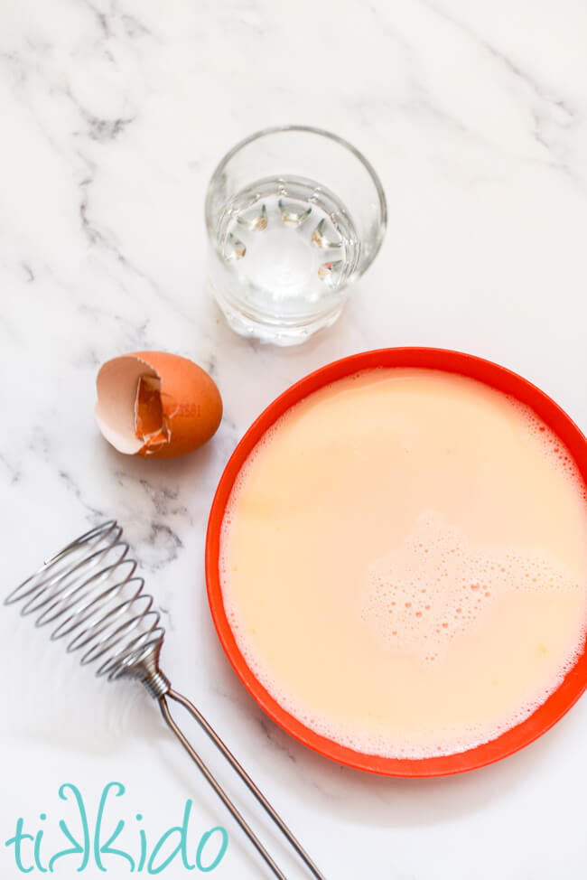 Egg wash made by beating an egg and some water for use in the healthy eggplant parmesan recipe.