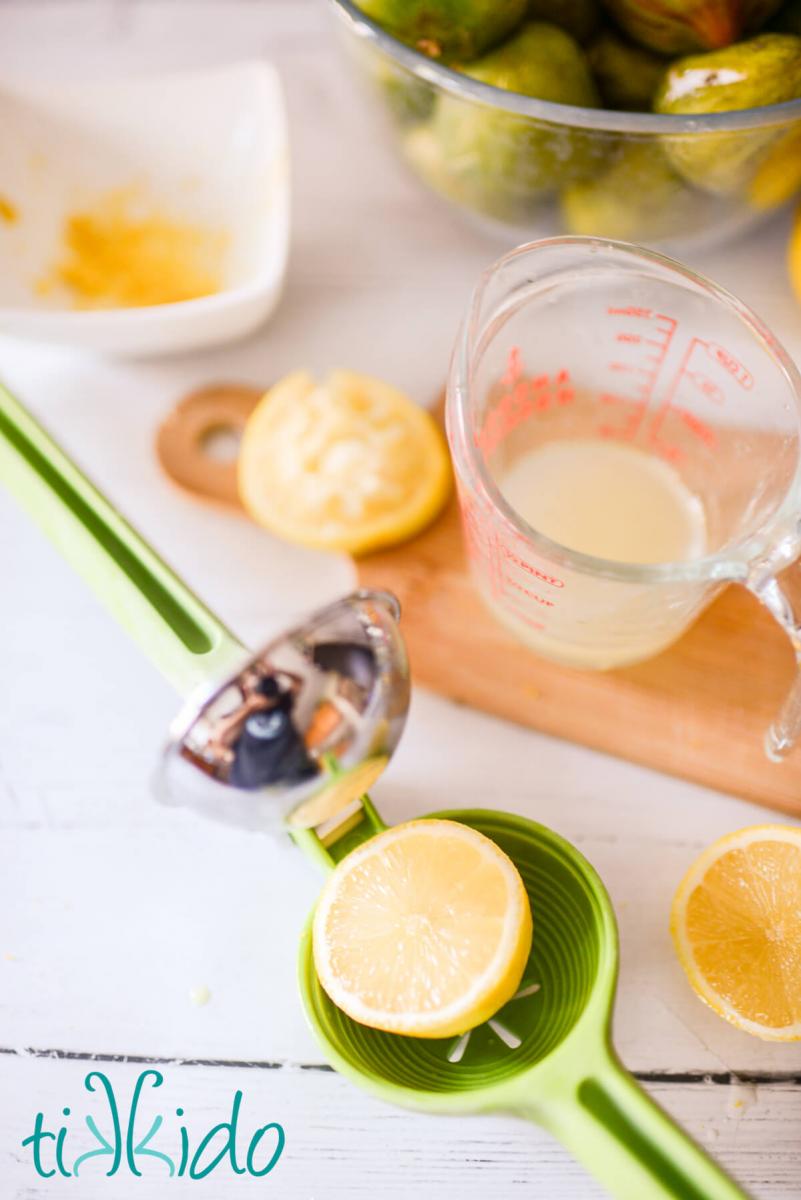 Lemon being juiced to make fresh fig jam.