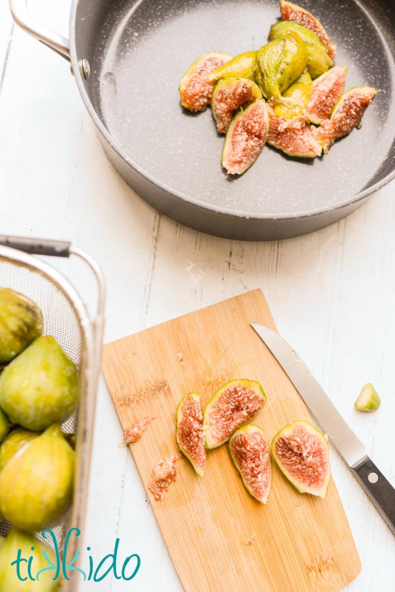 Fresh figs being sliced in quarters and put in a saucepan to make homemade fig jam.