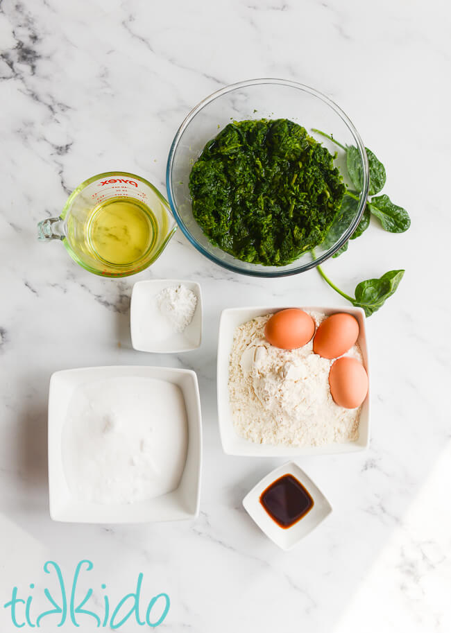 Ingredients for spinach cake (moss cake) on a white marble surface.