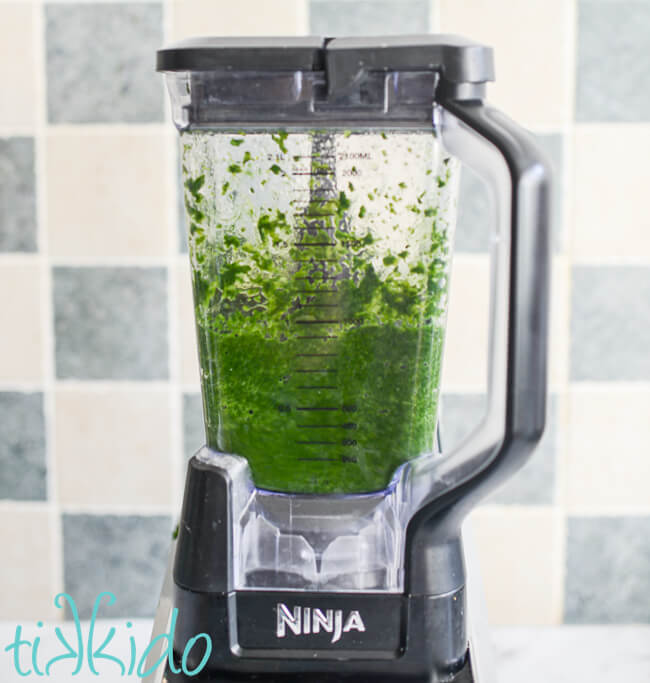 Frozen, defrosted spinach being pureed in a Ninja blender.