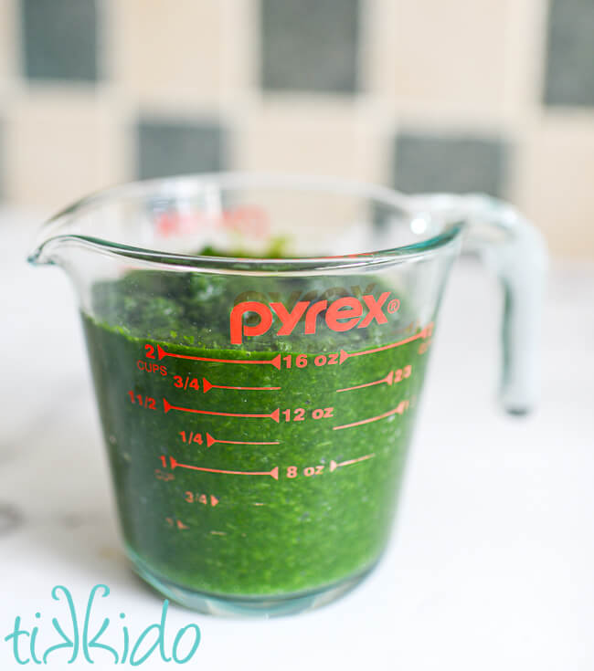 Two cups of spinach puree in a pyrex measuring cup, ready for making Forest Moss Cake.