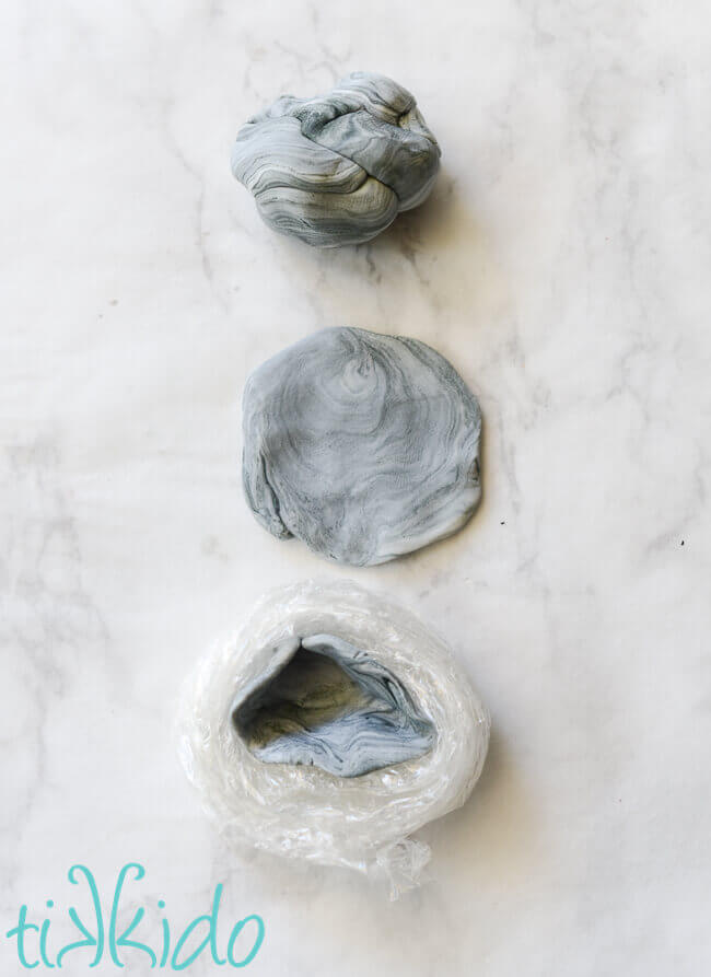 Marbled grey gum paste being shaped into edible geode cupcake toppers.