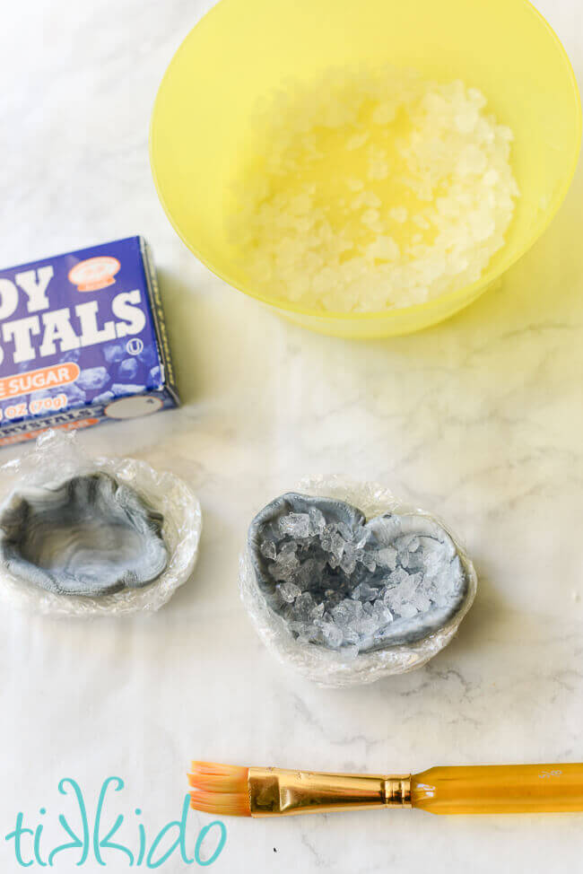 Clear sugar crystals being added to the inside of the gum paste geode cupcake topper