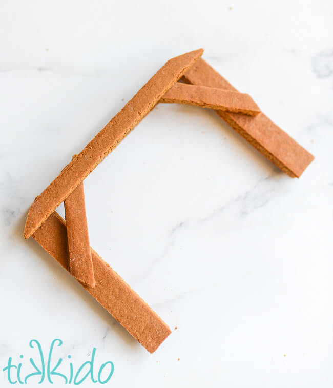 Finished assembled front beam section of a gingerbread nativity set on a white background.