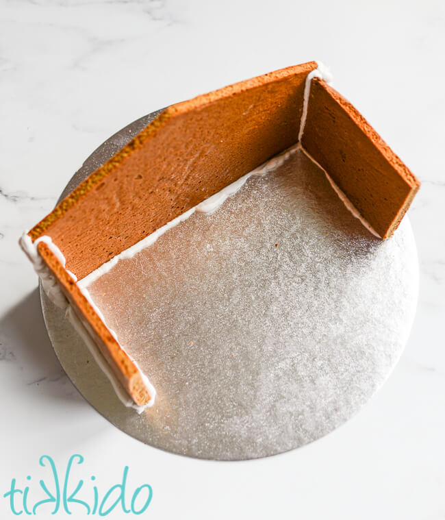 Back and side sections of the Gingerbread Nativity assembled on a 12" round silver cake board.