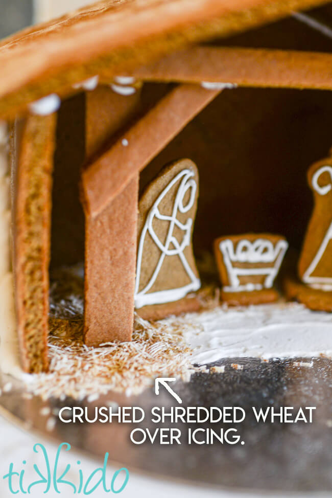 Interior shot of the Gingerbread Nativity with text overlay reading, "crushed shredded wheat over icing."