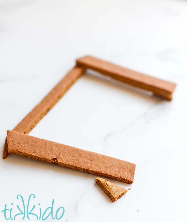 Pieces of the front beam section of the gingerbread nativity being assembled.