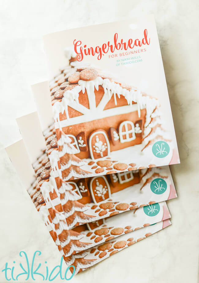 Four copies of the Gingerbread for Beginners book on a white marble background.