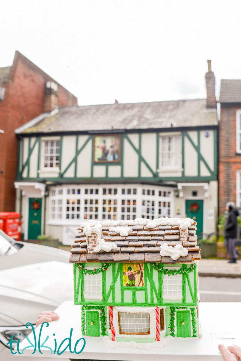 Gingerbread replica of The Robin Hood pub in St Albans, England, in front of the actual pub in the background.