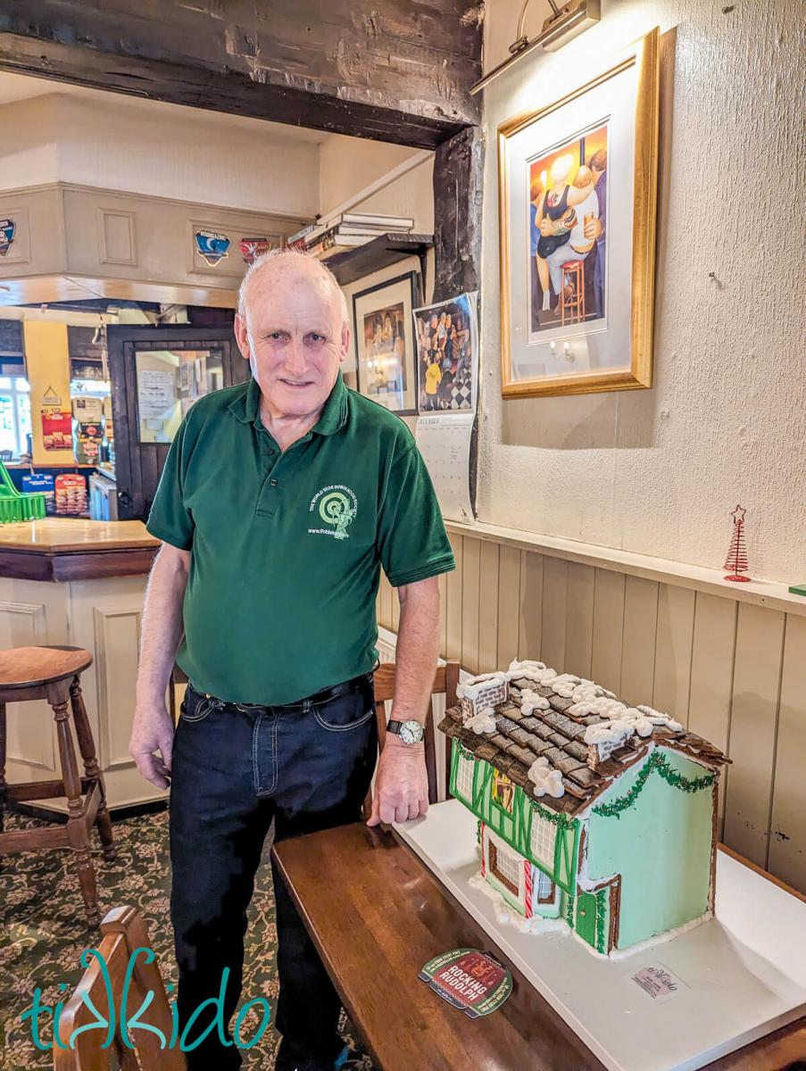 Owner of The Robin Hood pub with the gingerbread replica of the pub.