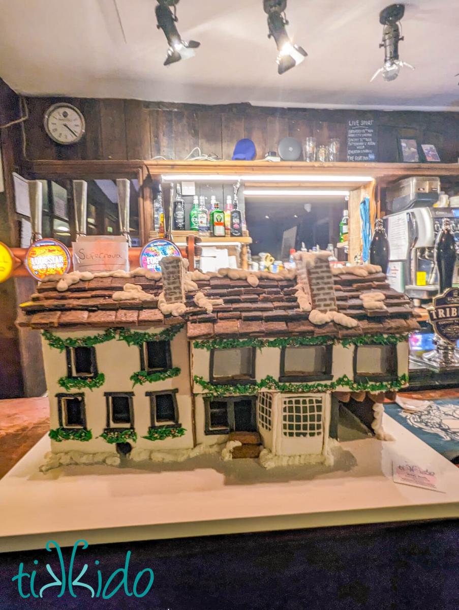 The gingerbread house replica of The Goat pub in St albans sitting on the bar inside the pub.