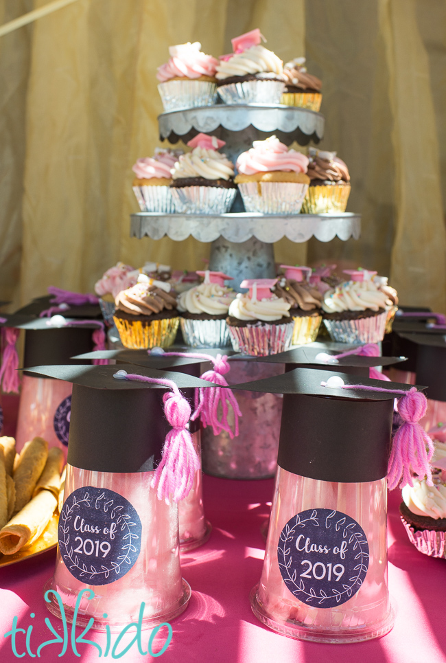 Cotton candy filled favors for a graduation party on display at a graduation party.