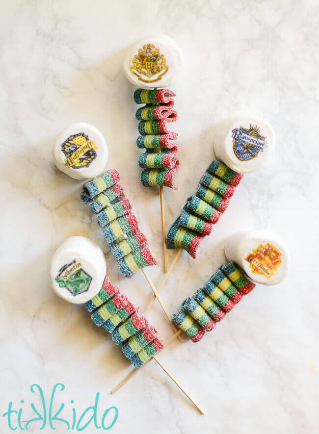 Harry Potter Candy Kebabs topped with marshmallows decorated with the Hogwarts house crests.