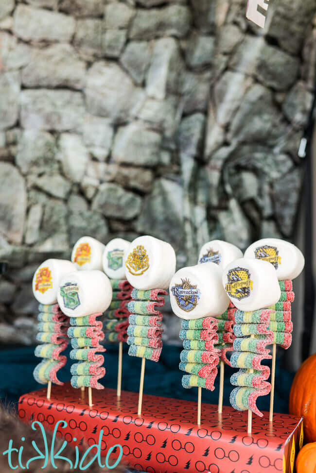 Harry Potter Candy Kebabs topped with marshmallows decorated with the Hogwarts house crests.