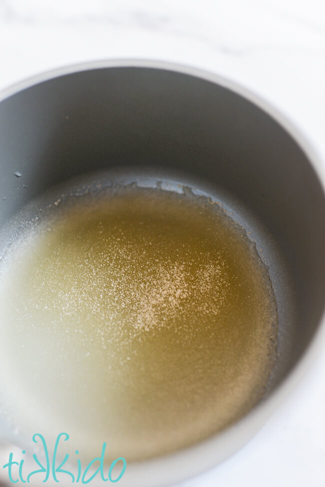 Gelatin softening in water in a small saucepan to make homemade rolled fondant.