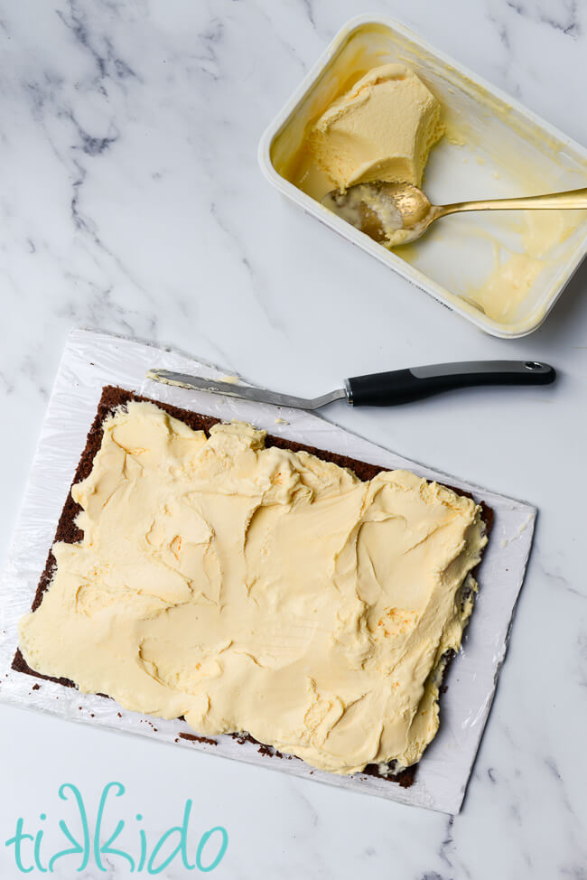 Homemade ice cream sandwiches being filled with vanilla ice cream.