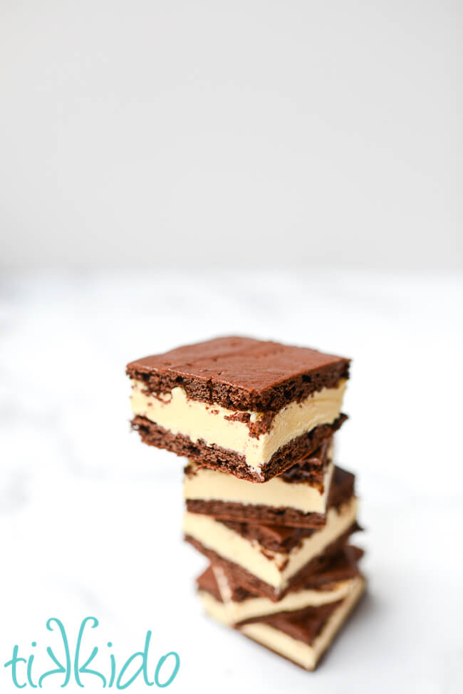 Five homemade ice cream sandwiches stacked on a marble surface.