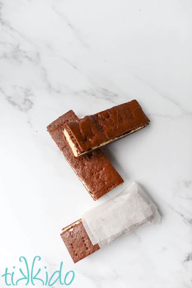 Three homemade ice cream sandwiches on a marble surface.