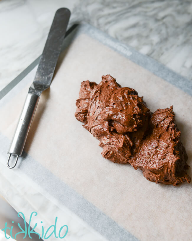 Batter for homemade ice cream sandwiches on parchment paper, ready to spread.