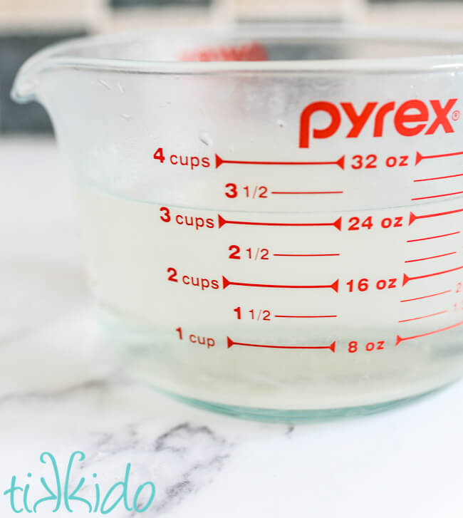 Simple syrup in a pyrex cup.