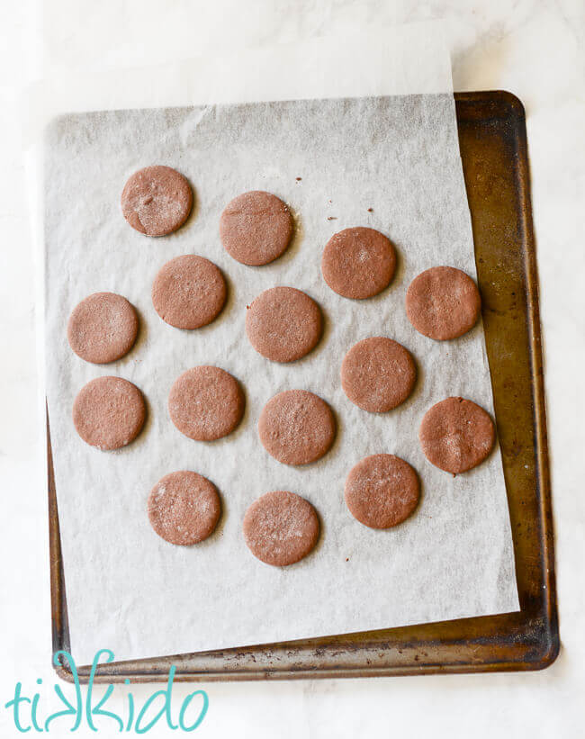 Homemade thin mints baked on a parchment lined cookie sheet.