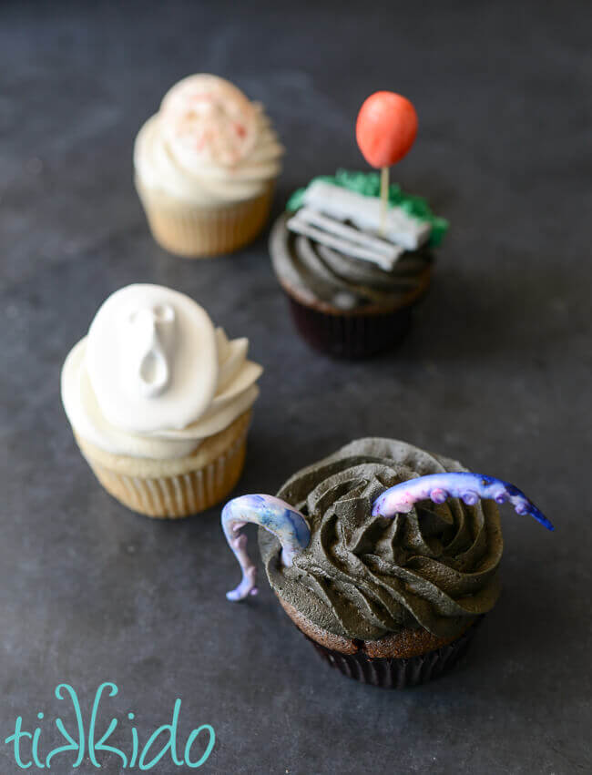 Horror movie themed cupcakes on a black background.