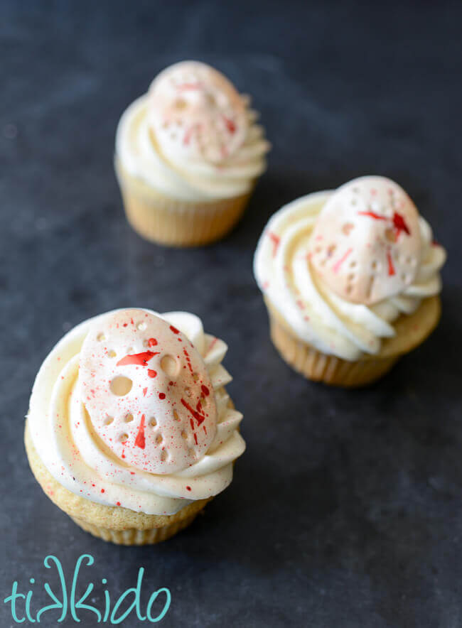 Three Friday the 13th movie cupcakes featuring gum paste edible Jason mask cupcake toppers.