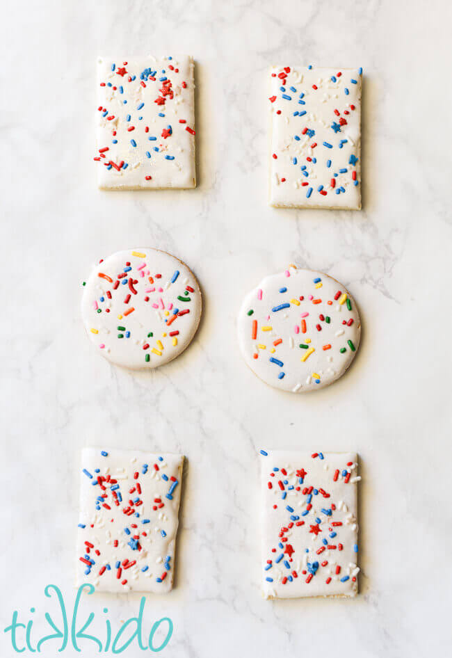 Sugar cookies dipped in royal icing and covered in sprinkles.